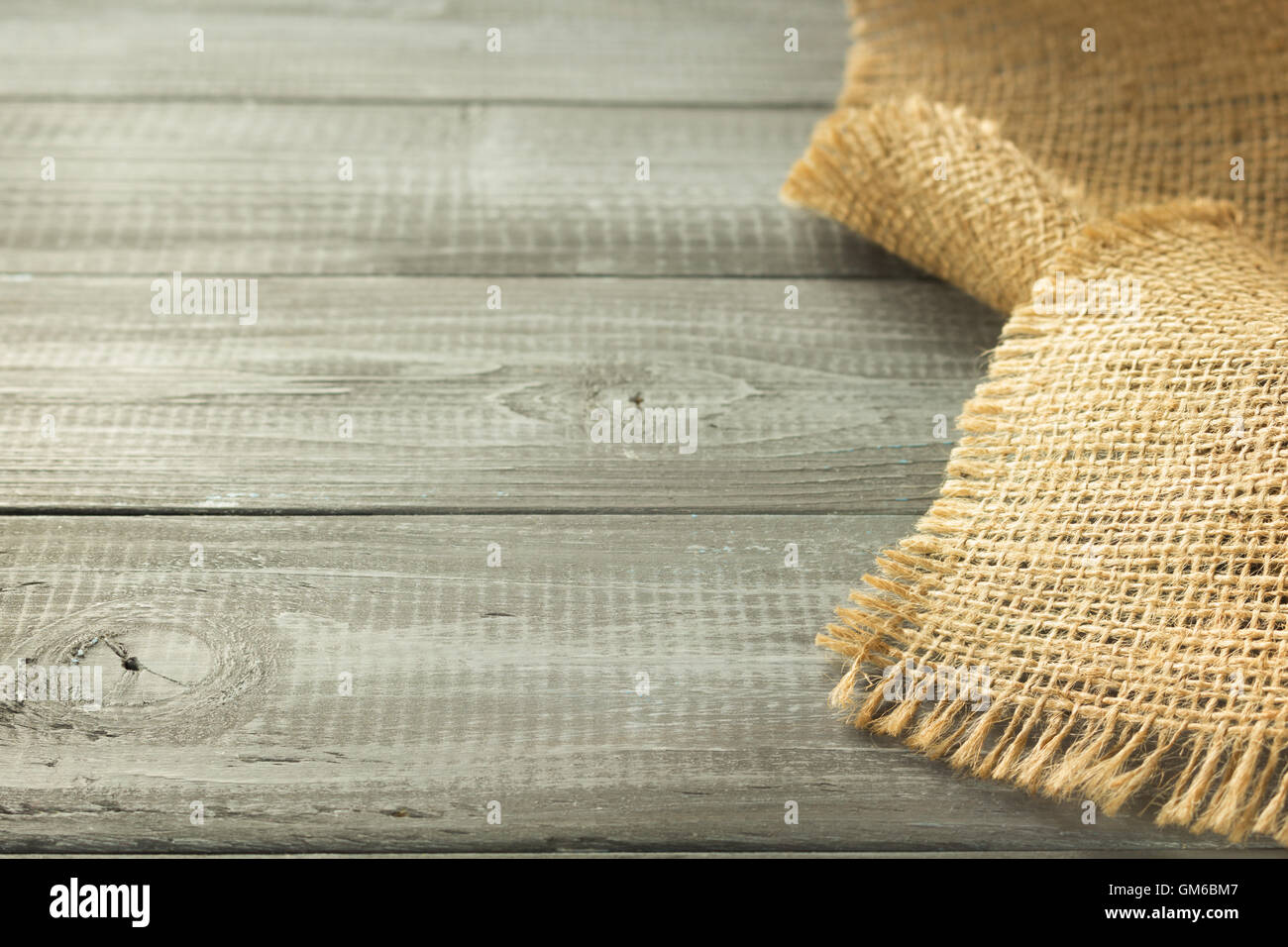 burlap hessian sacking on wooden background Stock Photo