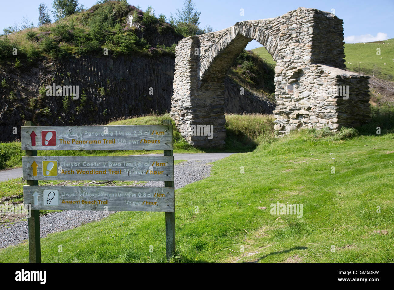 Walking trail signs old masonry Gothic arch Pontarfynachnear Devils Bridge Ceredigion Wales Stock Photo