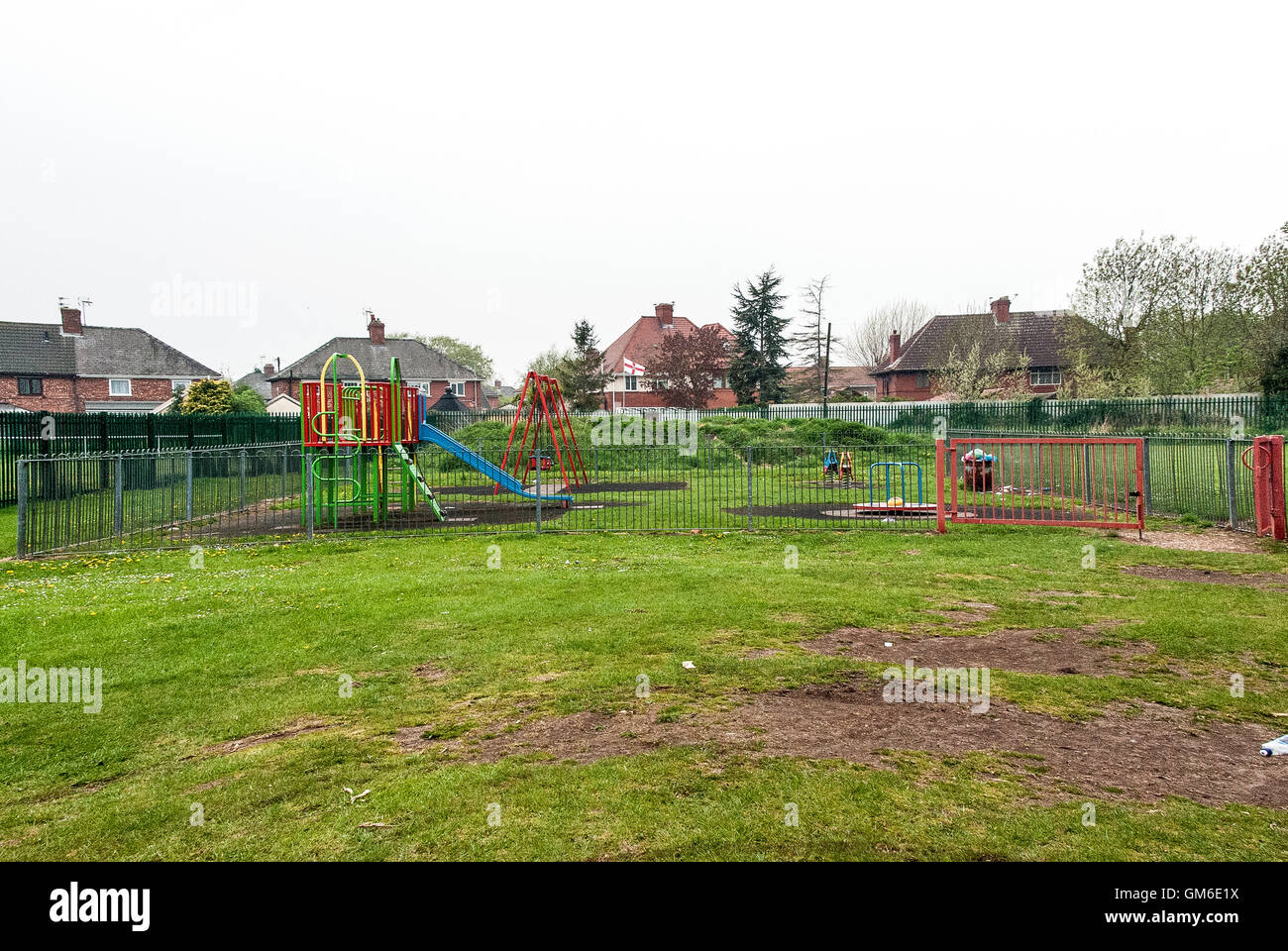 Deserted, Empty, Residential Park, Playground Equipment, Recreation Ground, Children's Park, Slide, Swings, Climbing Frame, Colourful, Litter Stock Photo