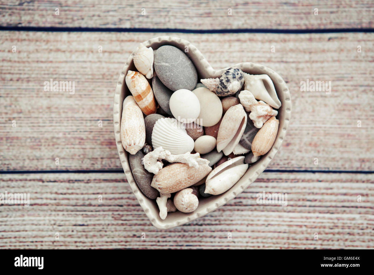 Souvenirs of the seaside in a heart shaped bowl Stock Photo