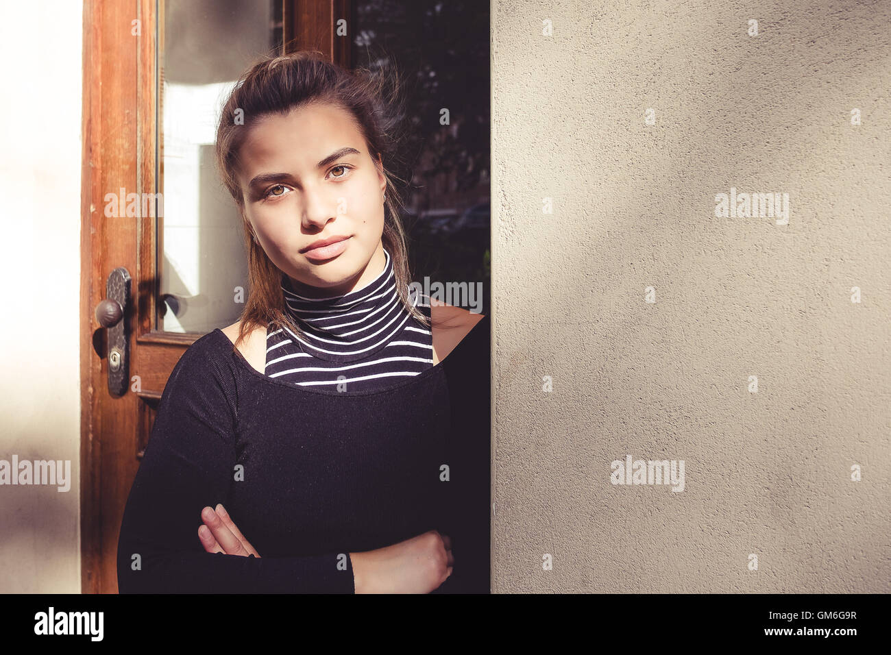 Beautiful mixed german-filipina woman is standing in front of a house Stock Photo