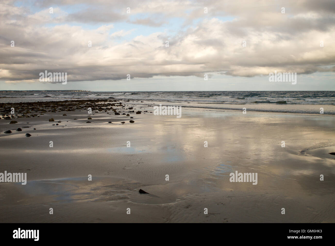 Beach with sky reflection on sand at Atlantic Ocean Stock Photo
