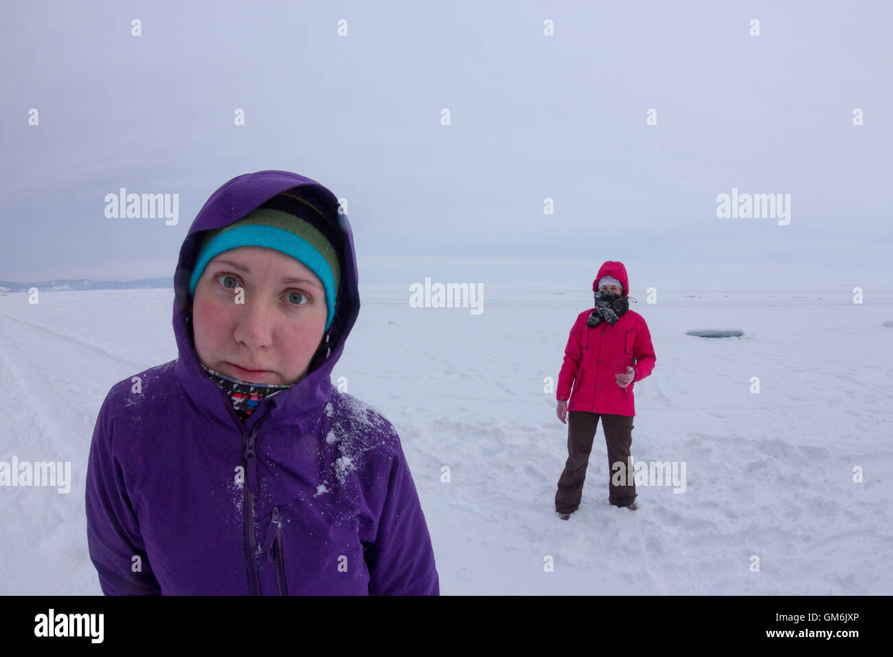 women play in the snow during snowfall on the ice of Lake Baikal Stock ...