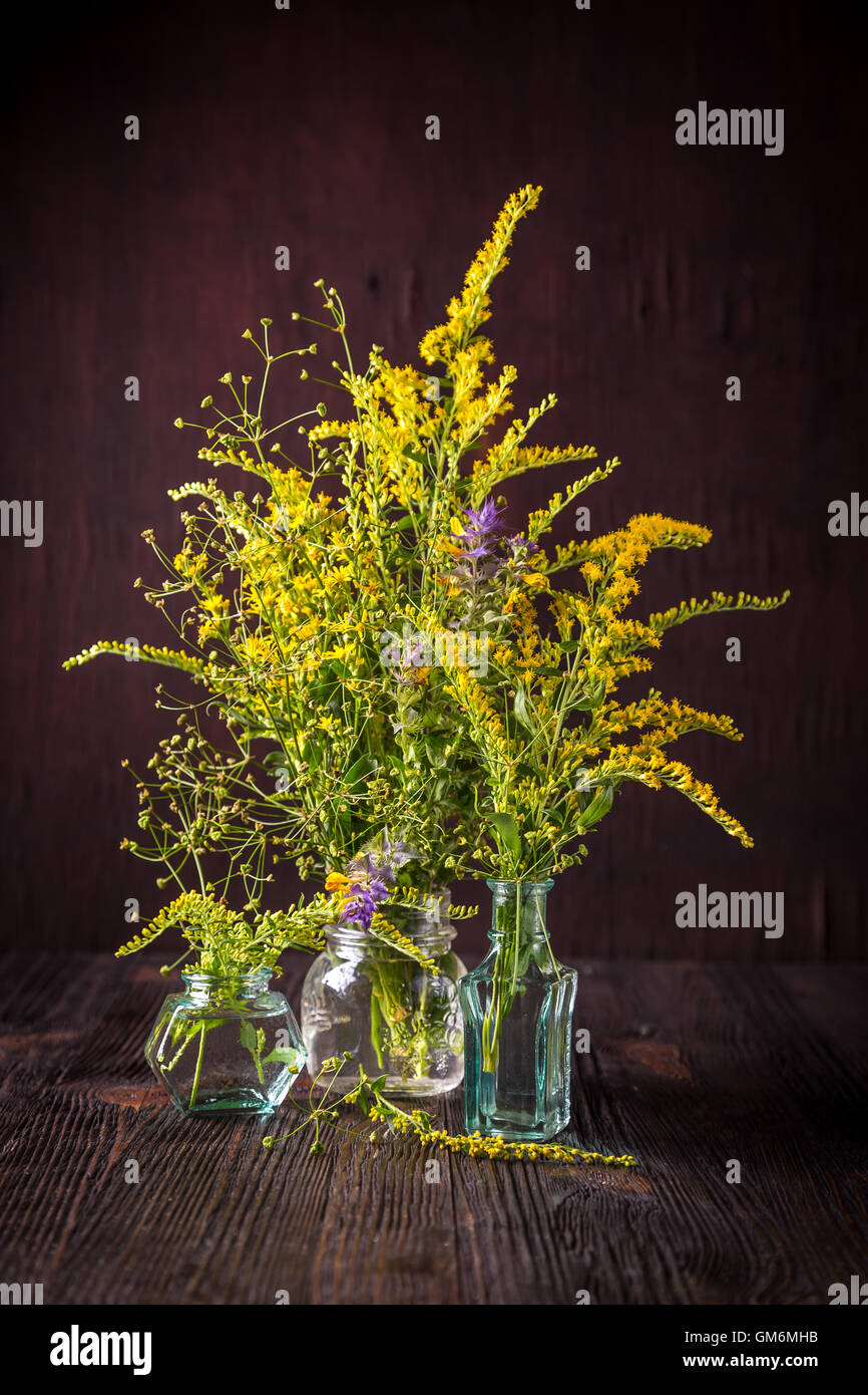 Wild flowers in a bouquet on a wooden table Stock Photo