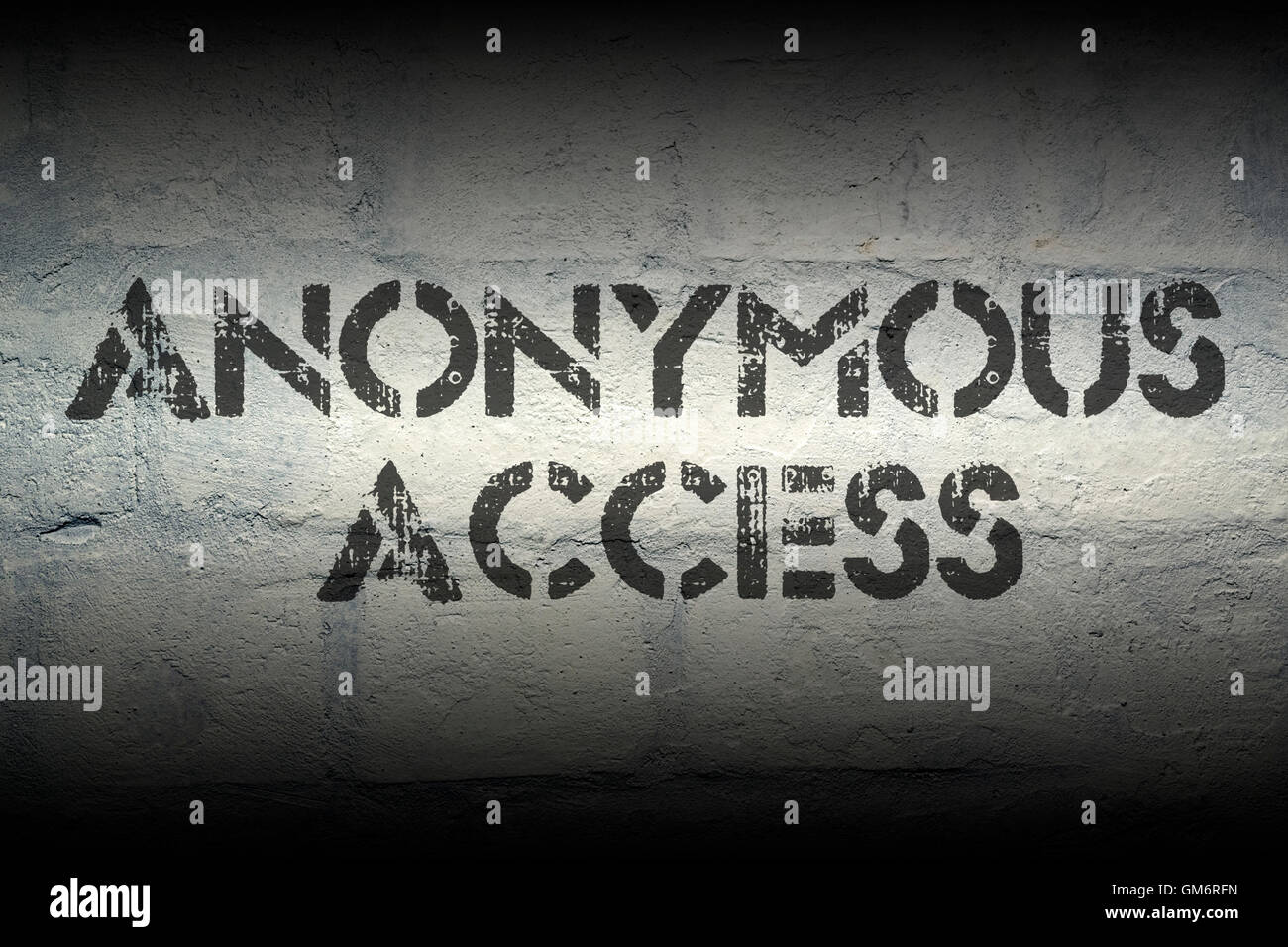 anonymous access stencil print on the grunge white brick wall Stock Photo
