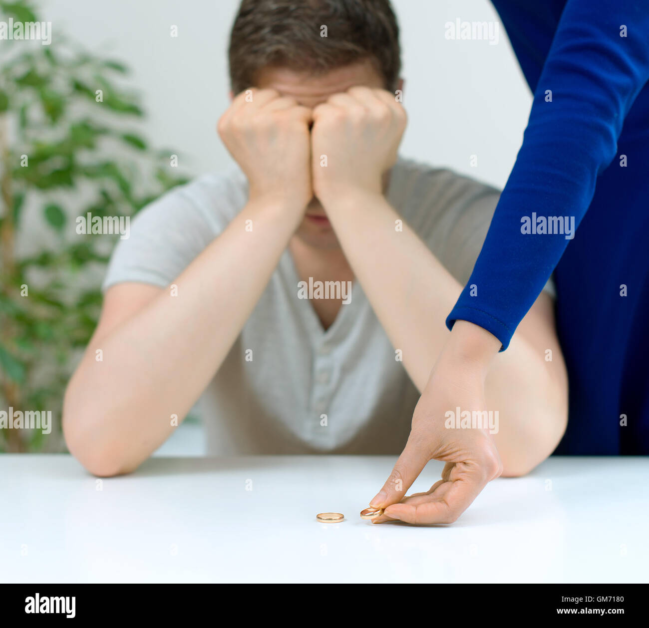 Divorce concept. Woman returning wedding ring to her husband Stock