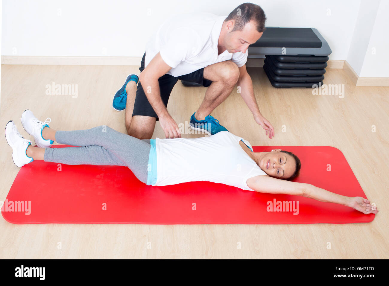 Personal coach correct stretching exercise Stock Photo - Alamy