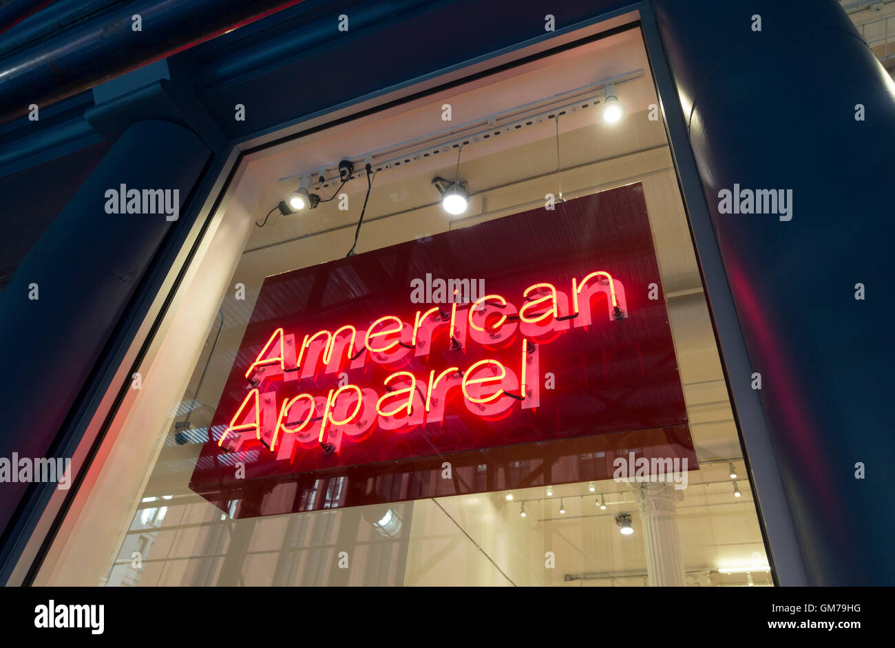 A neon sign in a shop window says American Apparel, which is both a brand name and a category of clothing Stock Photo