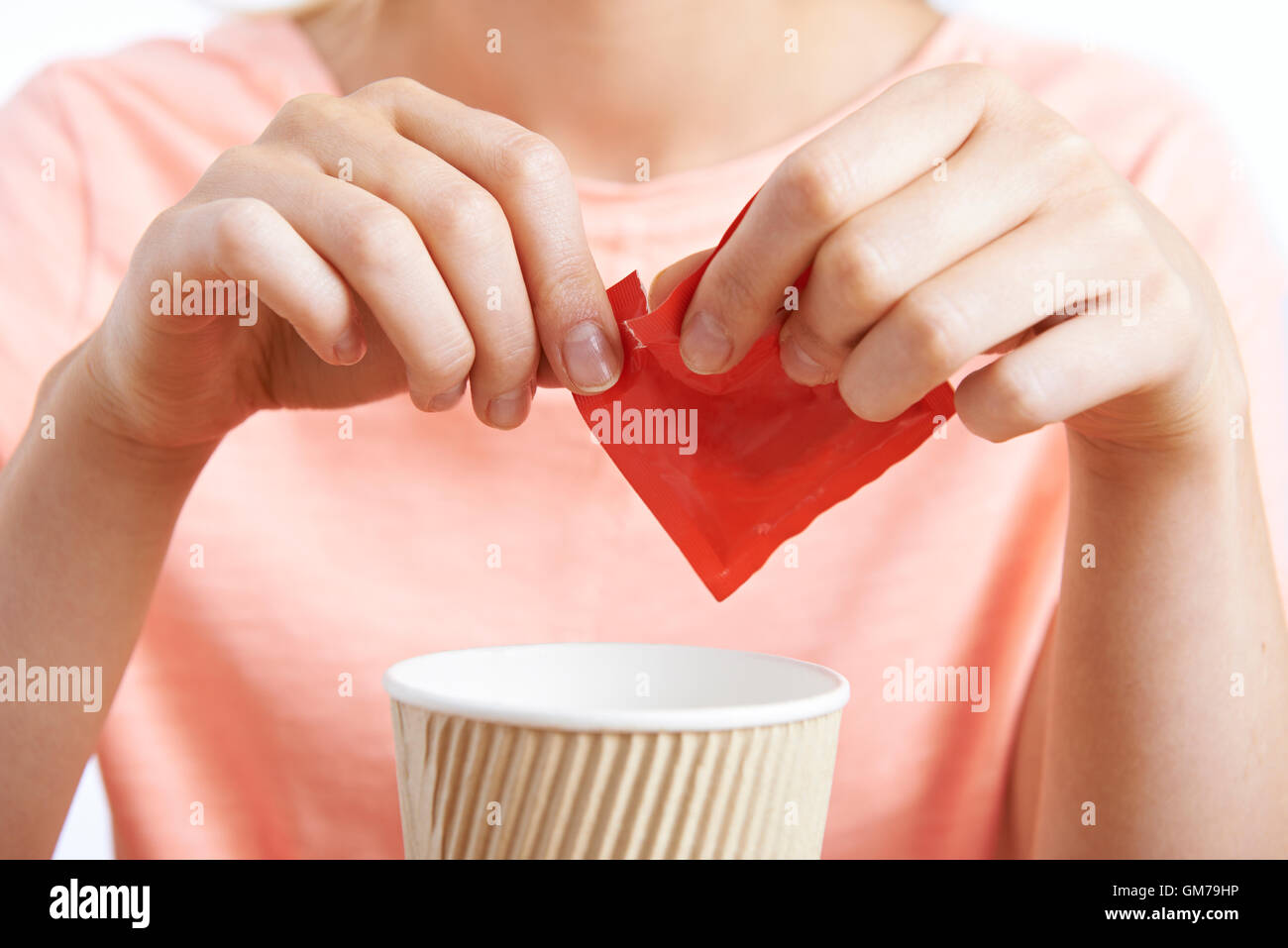 Woman Adding Artificial Sweetener To Coffee Stock Photo