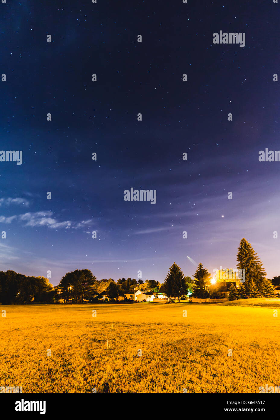 Backyard stars in night sky above a small neighborhood Stock Photo