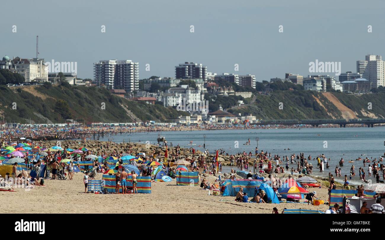 People enjoy the sun at Flaghead Chine beach in Poole, Dorset, as a