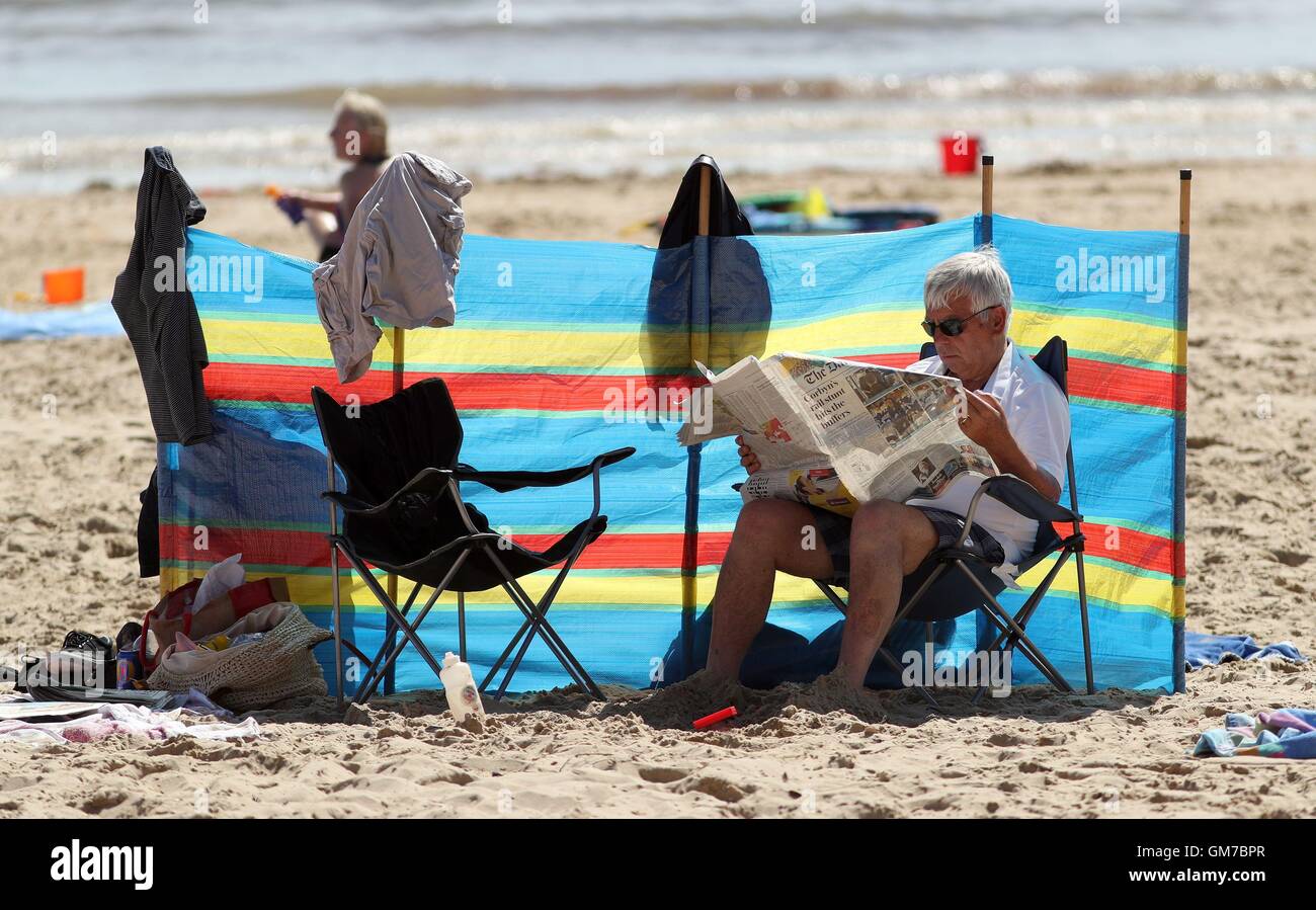 People enjoy the sun at Flaghead Chine beach in Poole, Dorset, as a