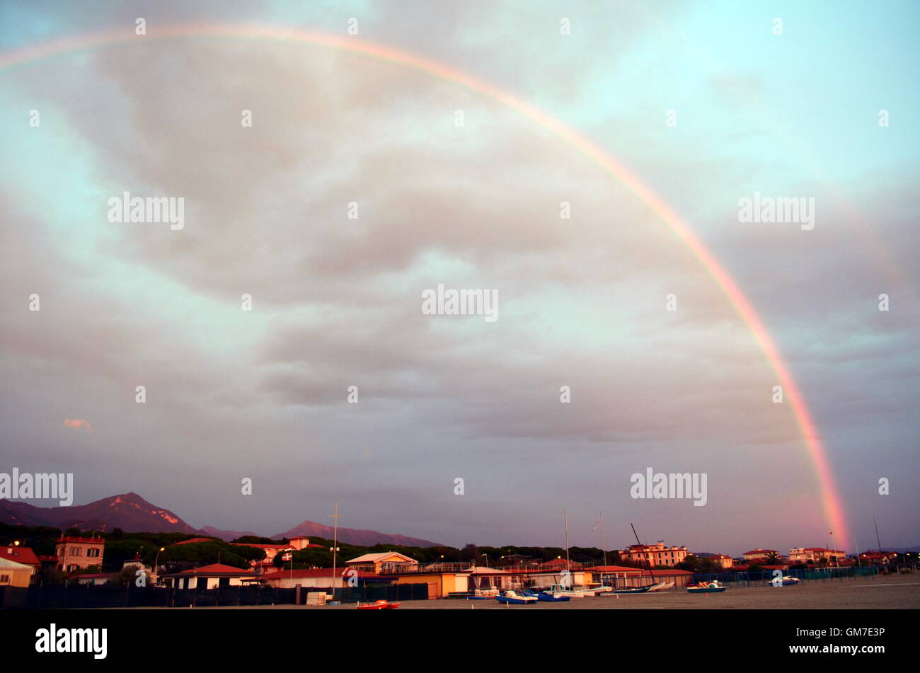 Rainbow is displayed across a sky after the storm Stock Photo