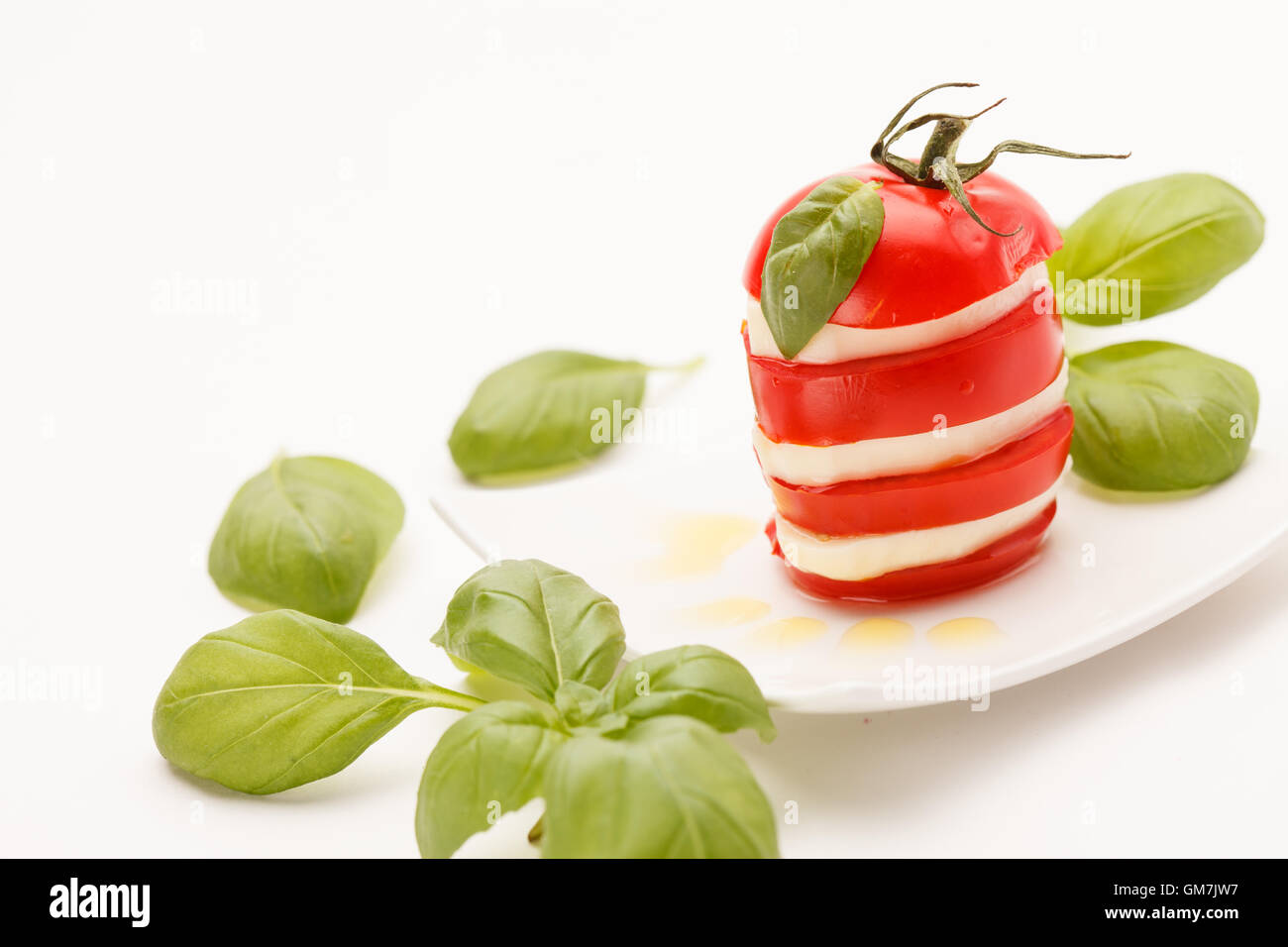 tomato and mozzarella slices decorated with basil leaves Stock Photo ...