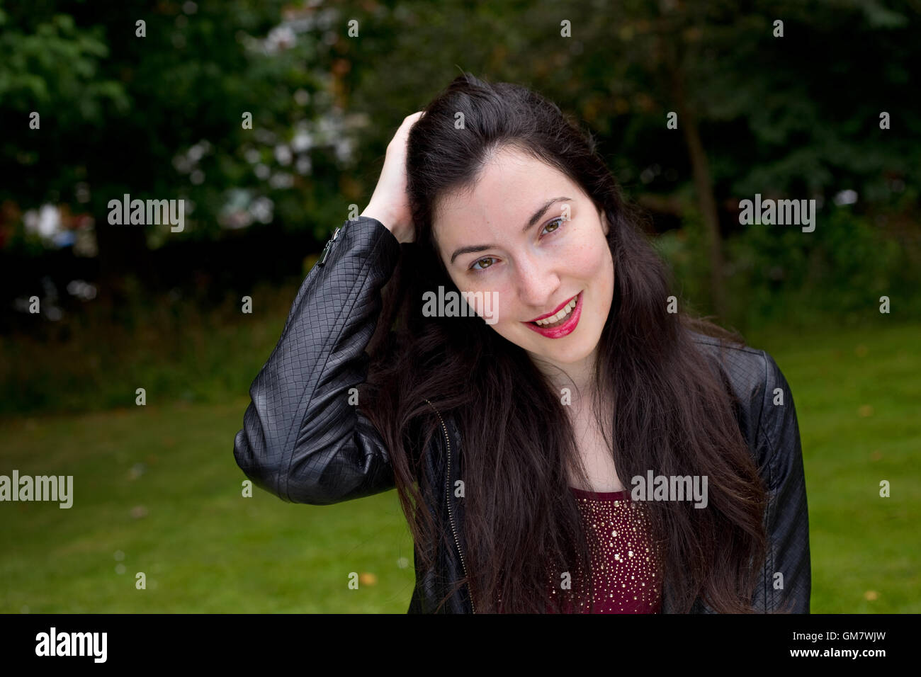 Portrait of a young woman in the park Stock Photo - Alamy