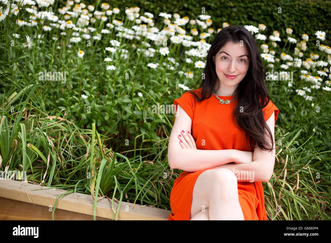 young woman sitting on a bench in the park Stock Photo - Alamy