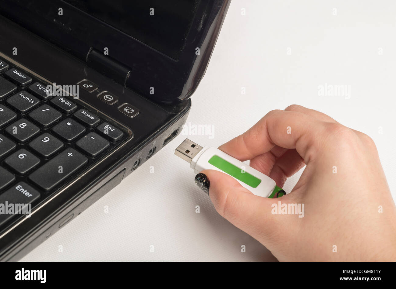 Hand inserting usb memory stick to laptop computer Stock Photo Alamy