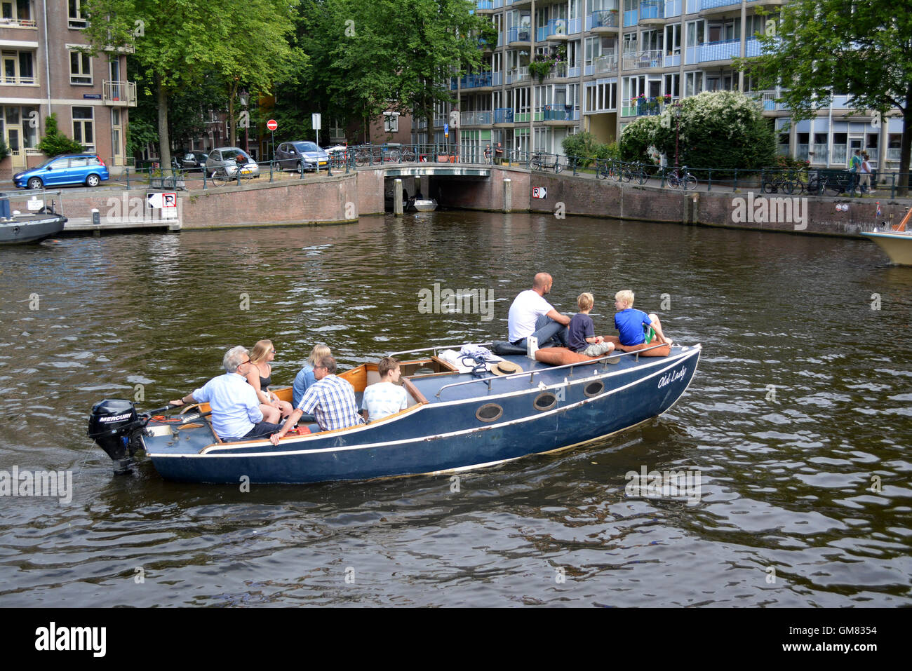 Family on a boat on a canal in Amsterdam. Stock Photo