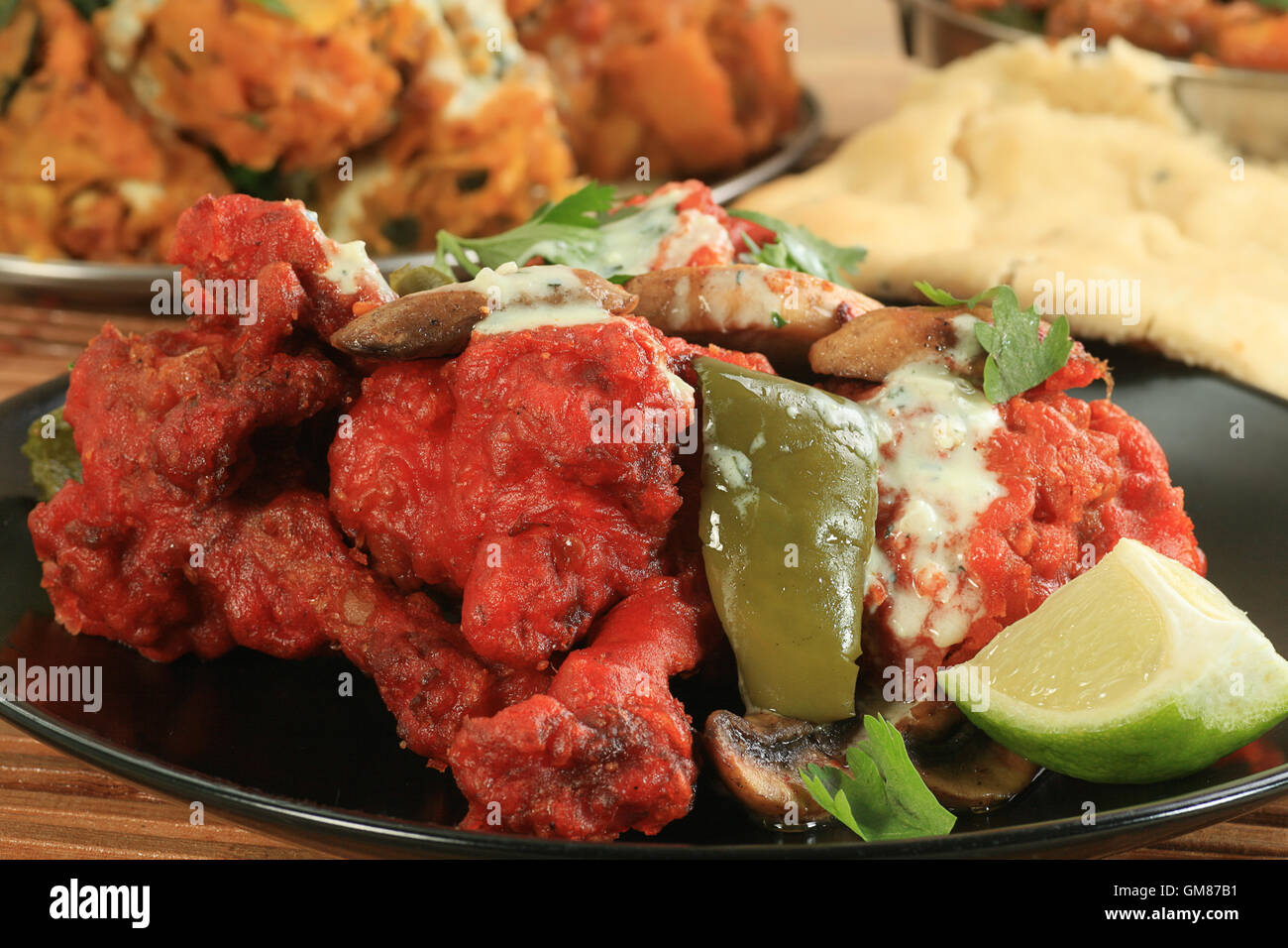 spicy tandoori chicken wings with peppers and mushrooms Stock Photo