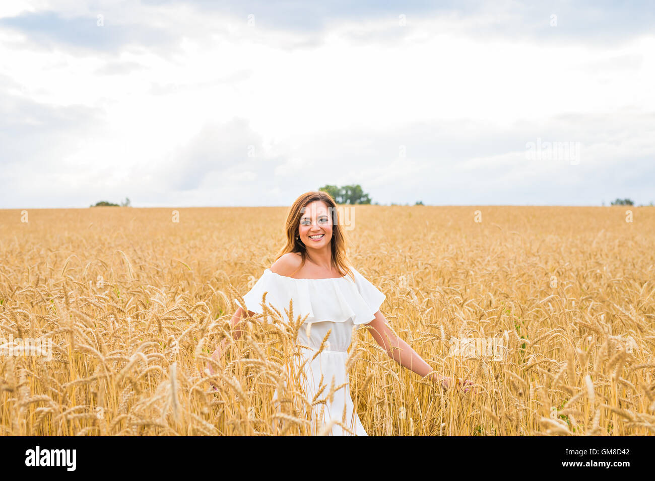 Young woman walking in the field Stock Photo - Alamy