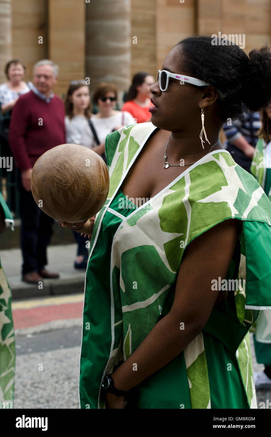 Black African female percussionist taking part in the Cavalcade, part