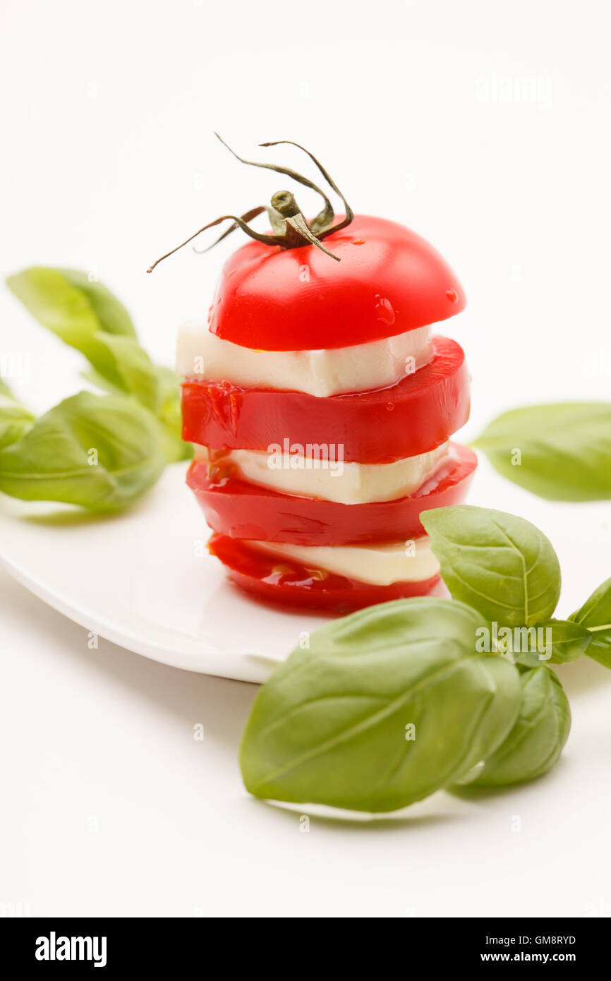 tomato and mozzarella slices decorated with basil leaves Stock Photo ...