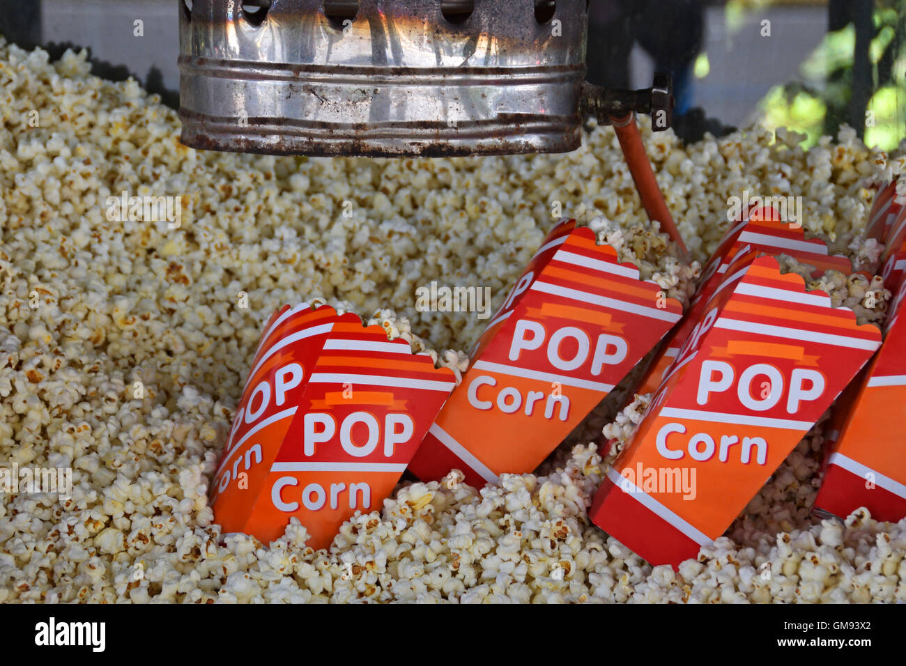 Pile of fresh popcorn and portions in bags made by antique hot air