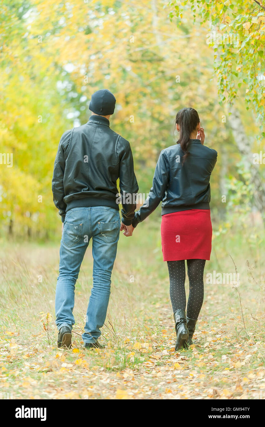 Affectionate couple taking walk in autumn park Stock Photo - Alamy