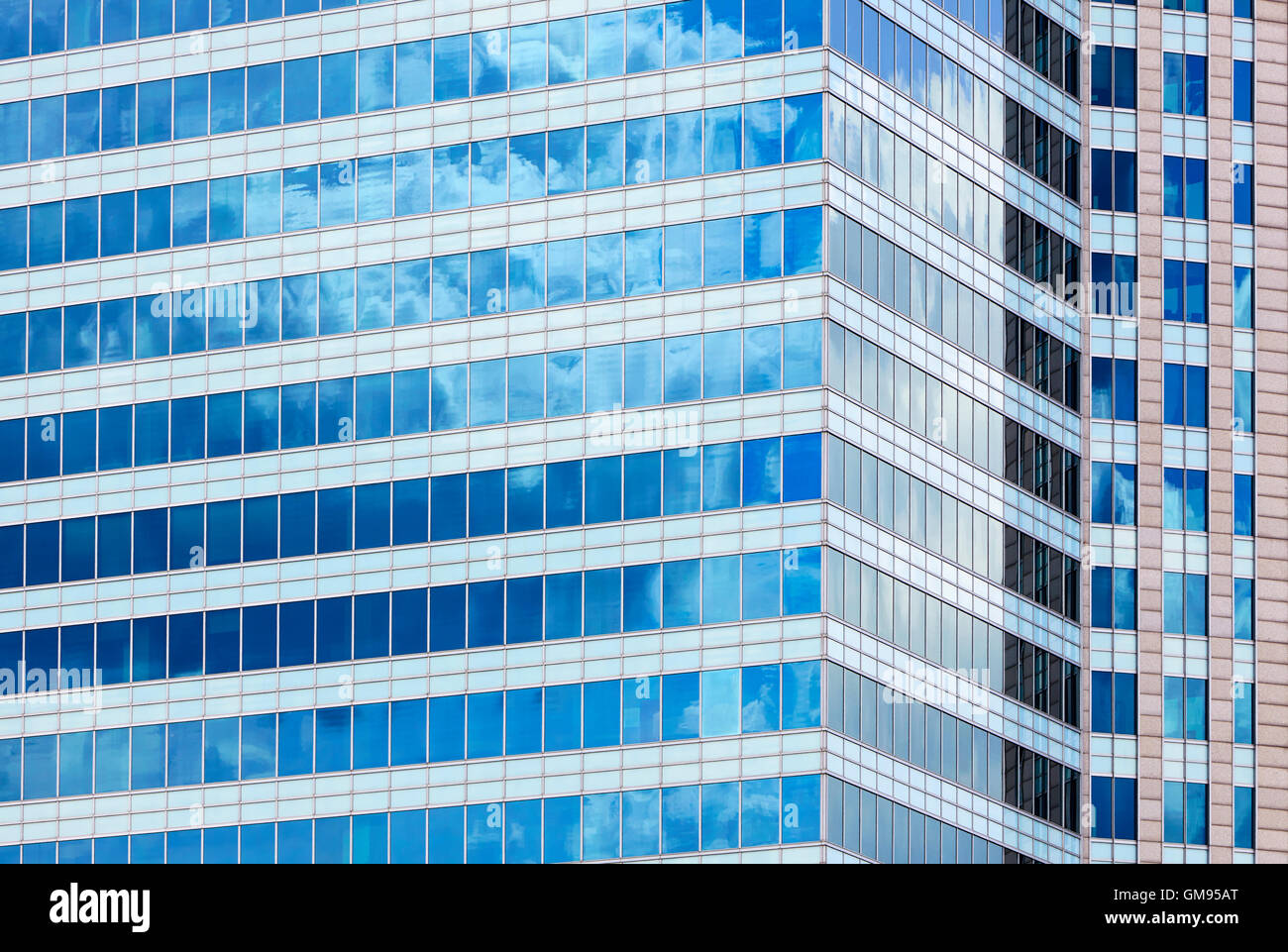 Glass facade of a modern building and sunny blue sky. Background Stock ...