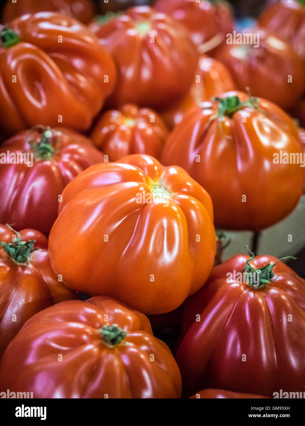 Fresh red ripe tomatoes in wooden baskets on sale on a farmers Borough ...