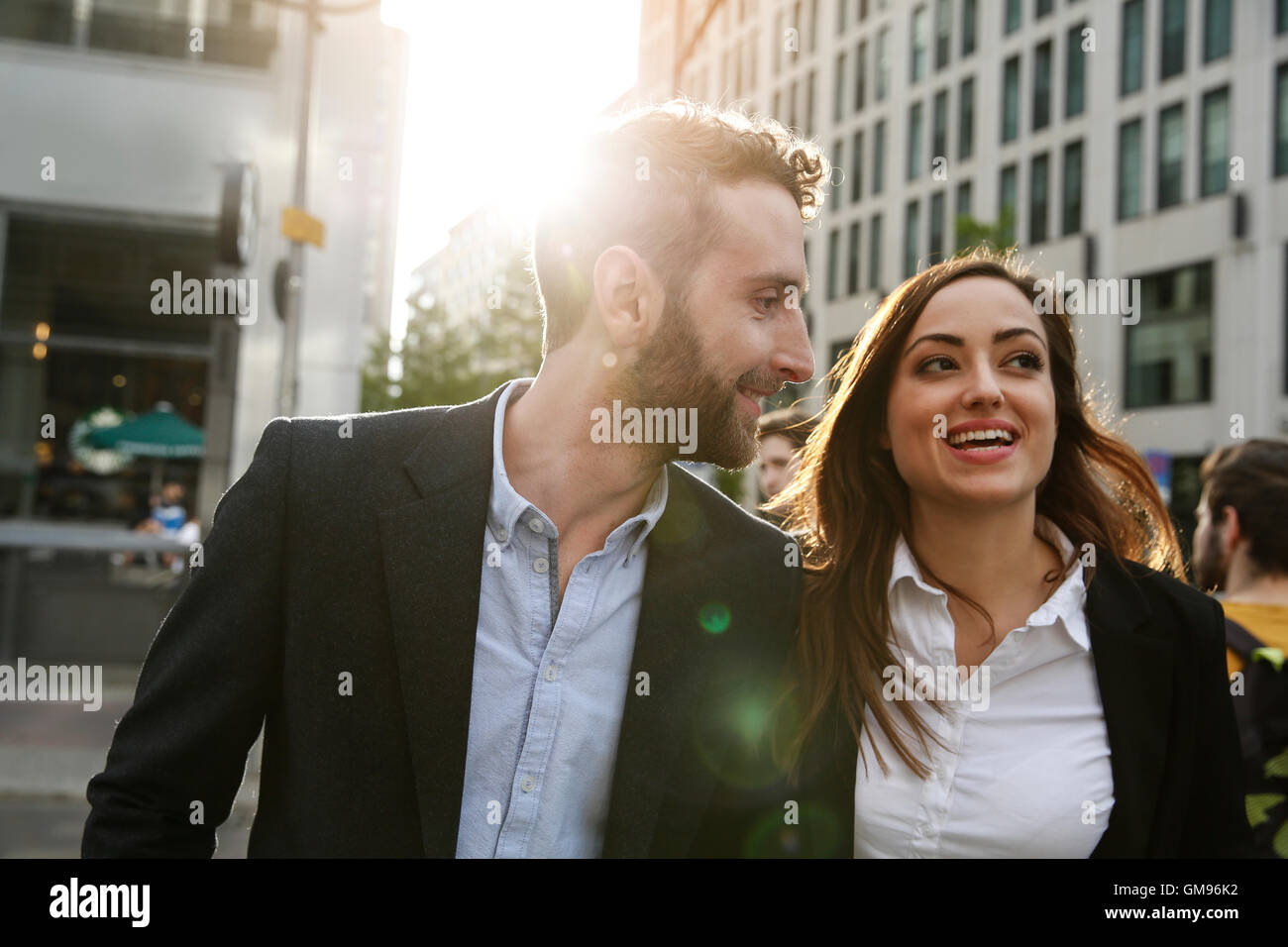 Smiling young businesswoman and businessman outdoors Stock Photo - Alamy