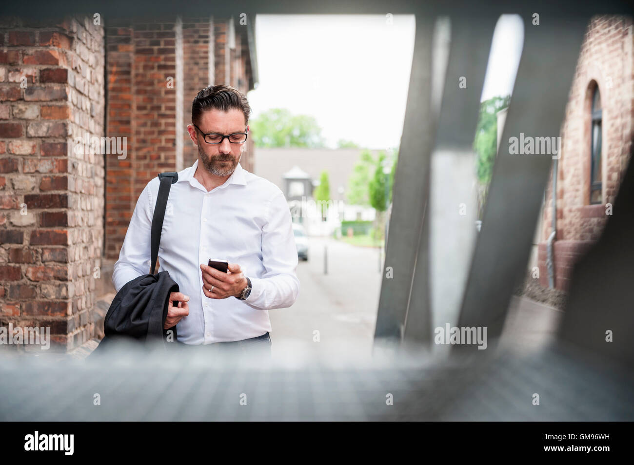 Businessman looking at cell phone Stock Photo