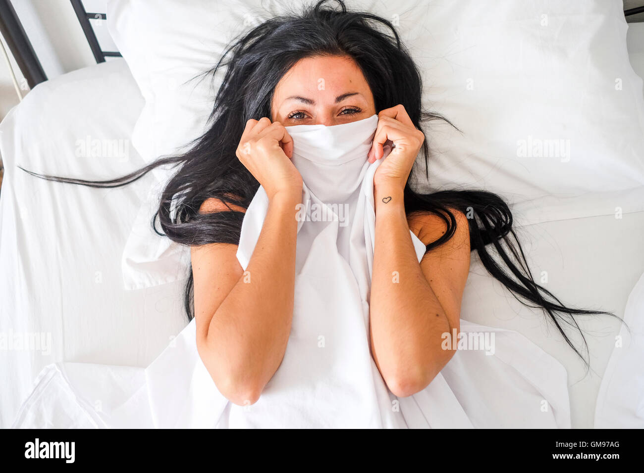 Woman lying in bed, obscured face Stock Photo Alamy