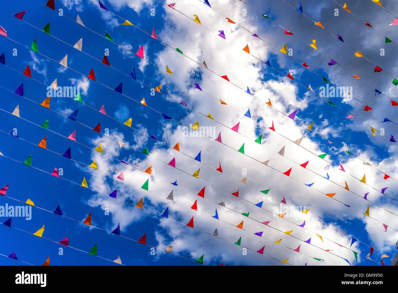 Colored flags against a blue sky Stock Photo - Alamy