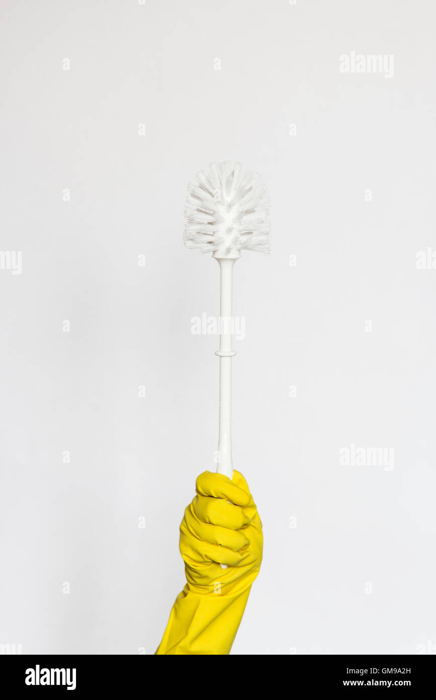 Yellow rubber glove holding toilet brush Stock Photo Alamy