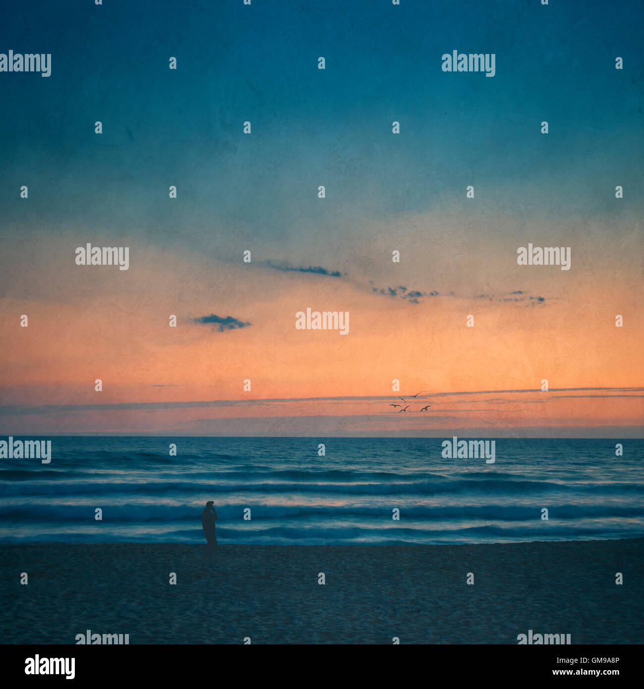 Silhouette of man on the beach at sunset Stock Photo - Alamy
