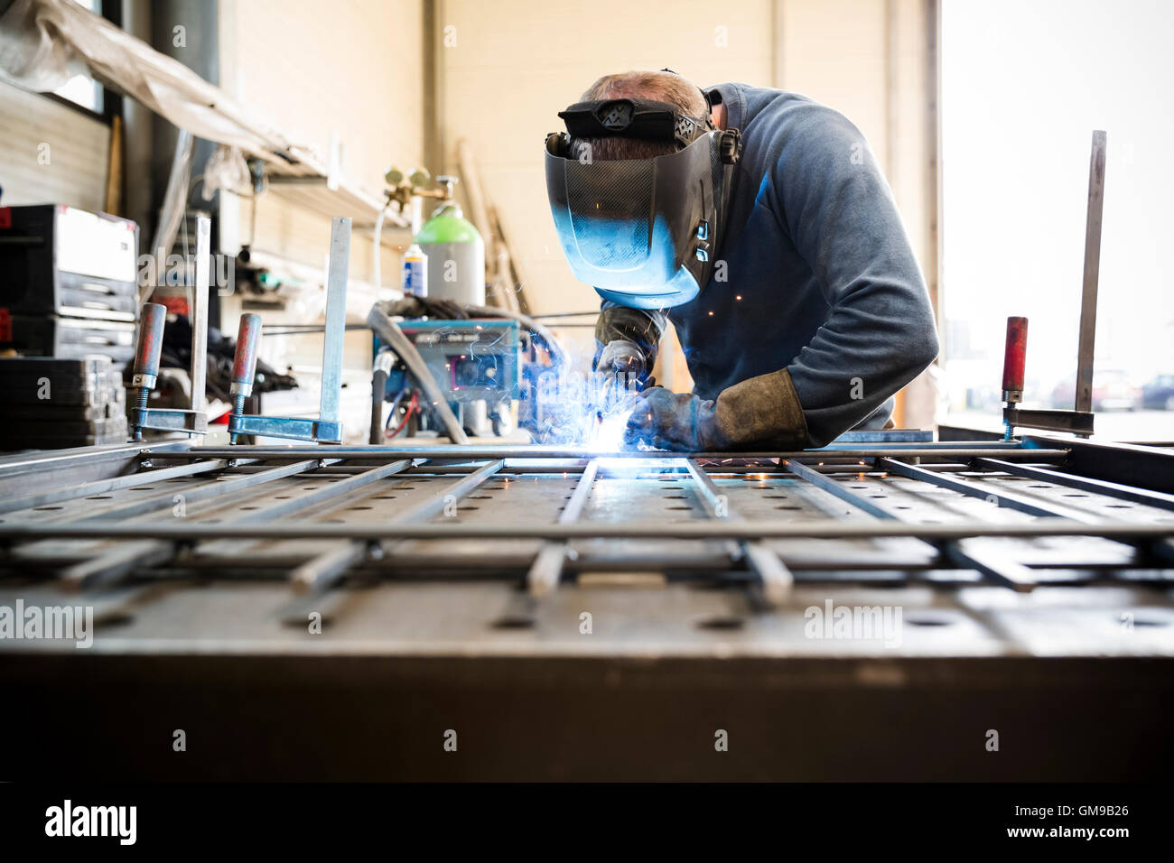 Metal construction, welder welding railing Stock Photo Alamy