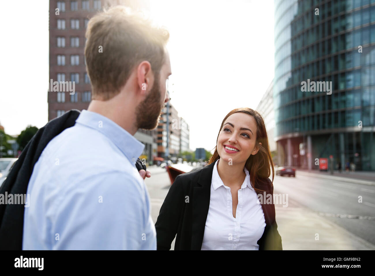 Smiling young businesswoman and businessman outdoors Stock Photo - Alamy