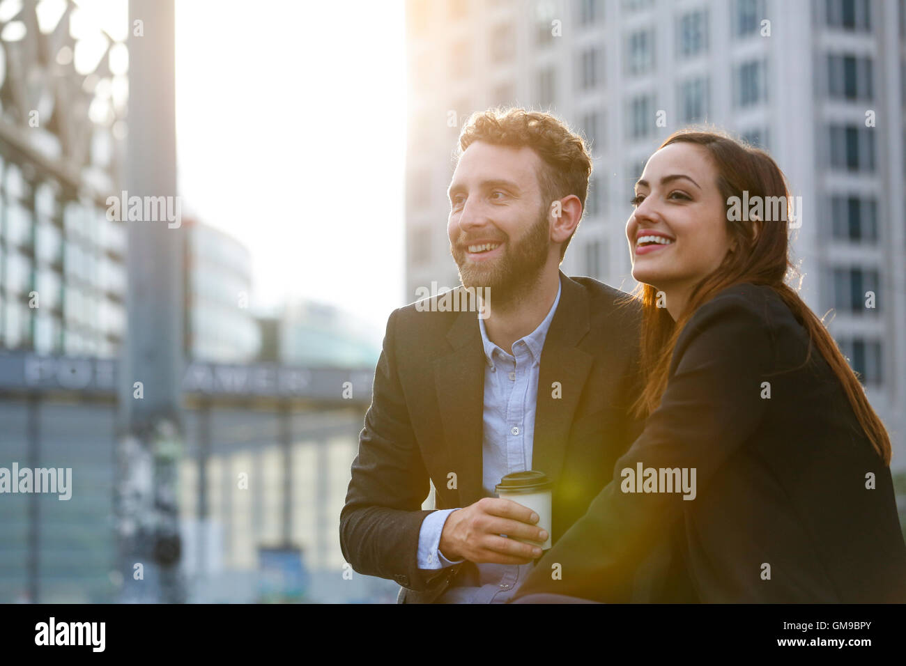 Smiling young businesswoman and businessman outdoors Stock Photo - Alamy