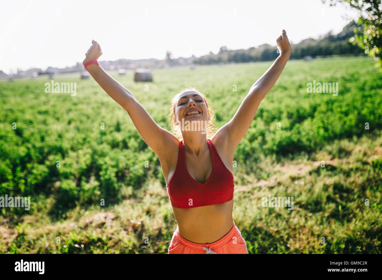 Sportswoman raising arms hi-res stock photography and images - Alamy
