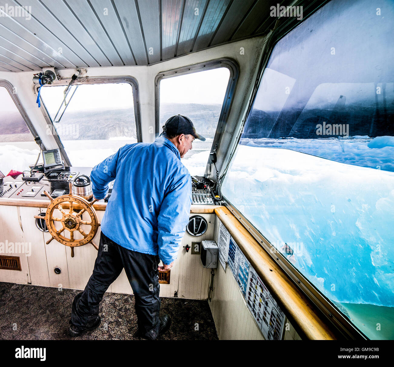 Ice Berg Ahead Ferry Boat Captain in Lake Grey Patagonia Chile Stock