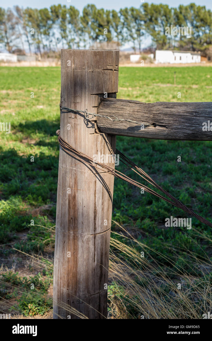 Weathered fence post with rusty wire stays Stock Photo Alamy