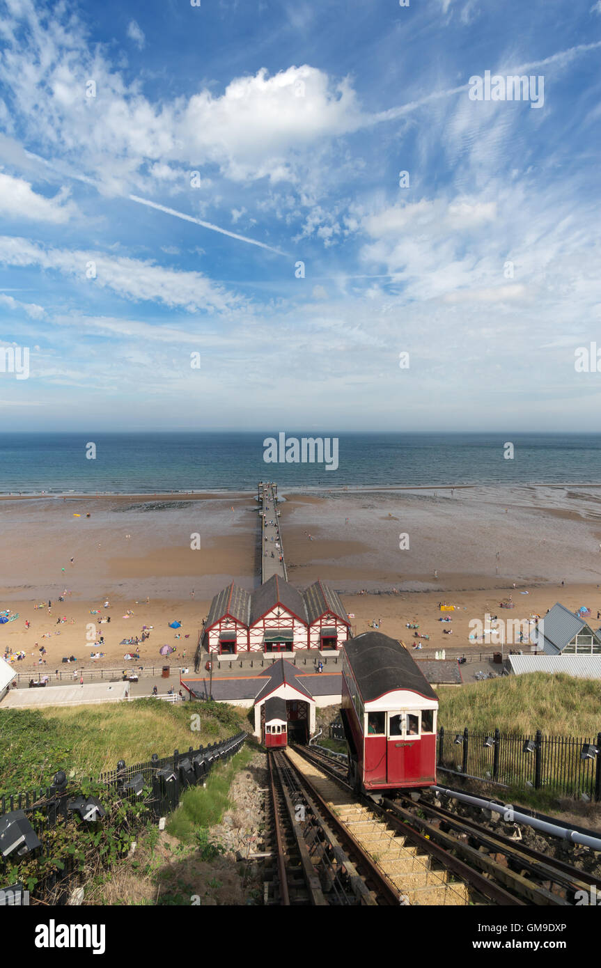 Wide angle view of Saltburn pier, cliff lift, and beach under a summer sky, Saltburn by the Sea, North Yorkshire, England, UK Stock Photo
