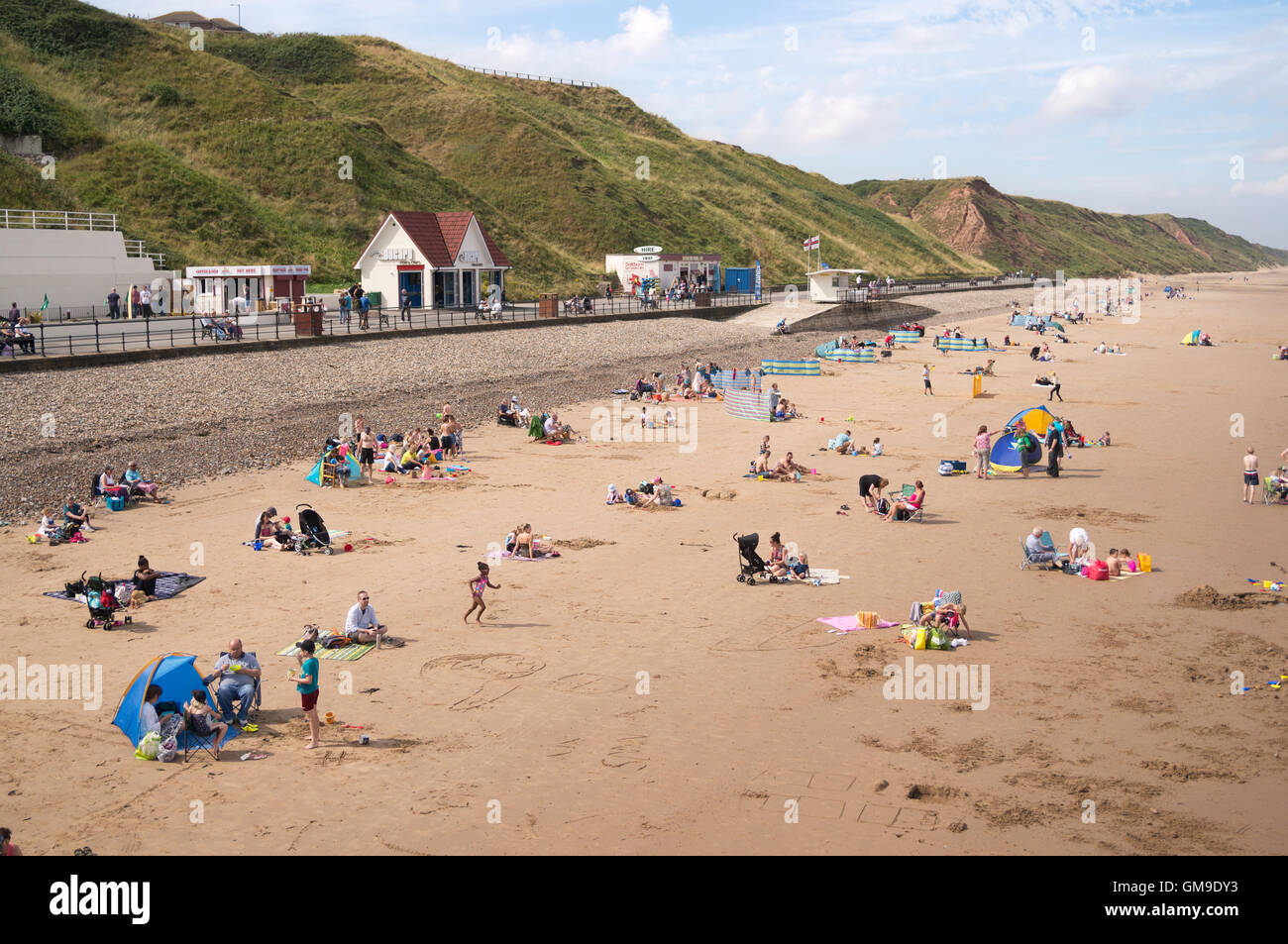People enjoying summer sunshine, the beach at Saltburn by the Sea, North Yorkshire, England, UK Stock Photo