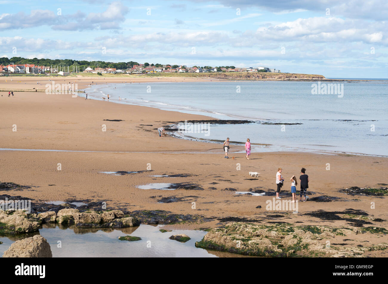 People near rockpools and sandy beach Seaburn, Sunderland, Tyne and Wear, England, UK Stock Photo