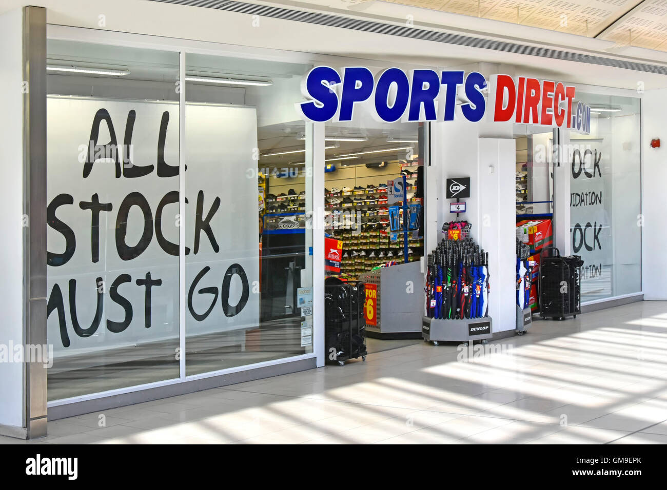 Sports Direct shop front indoor shopping Mall 'All Stock Must Go' slogan banners in store window at Intu Lakeside shopping centre Thurrock Essex UK Stock Photo