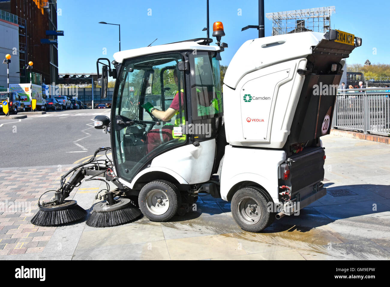 London Borough of Camden England UK local council street cleaning by compact mechanical road & pavement sweeper machine in use and operated by Veolia Stock Photo