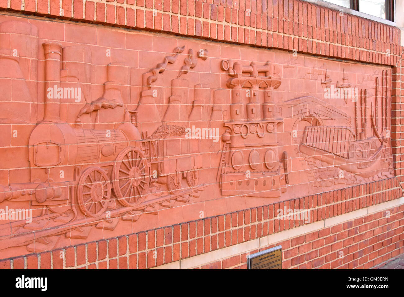 A brick frieze illustrating the historical Industrial Heritage of the UK town of Rugby in Warwickshire including railways aviation and canals Stock Photo