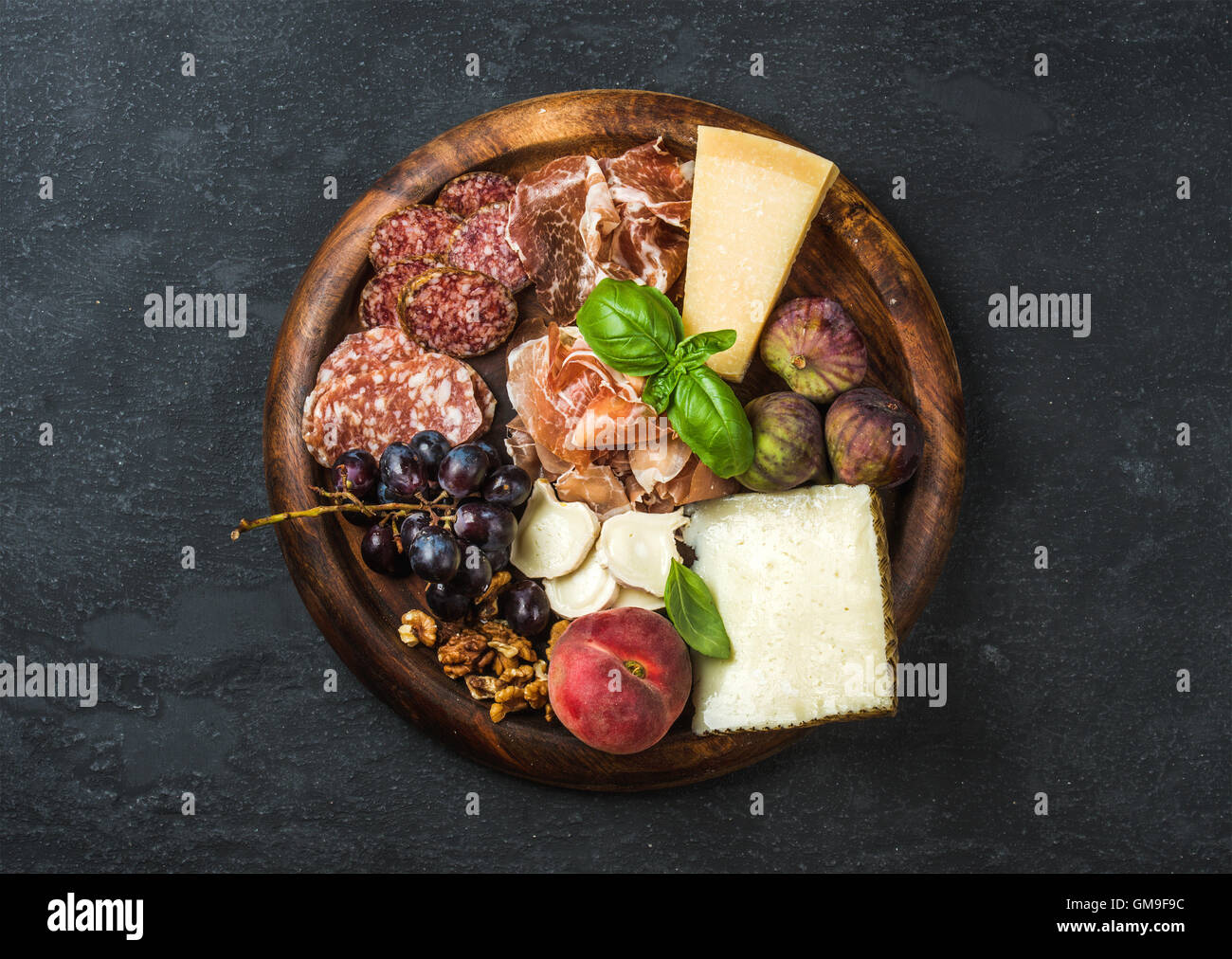 Italian antipasti snacks variety for wine on wooden tray Stock Photo