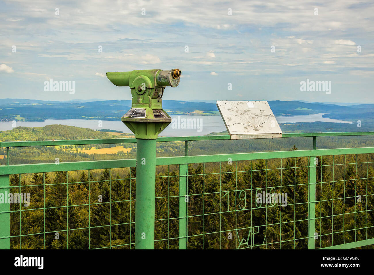 Vintage coin green lookout binocular with view at Czech countryside, river Vltava, Lipno lake, 200 km south of Prague. Stock Photo